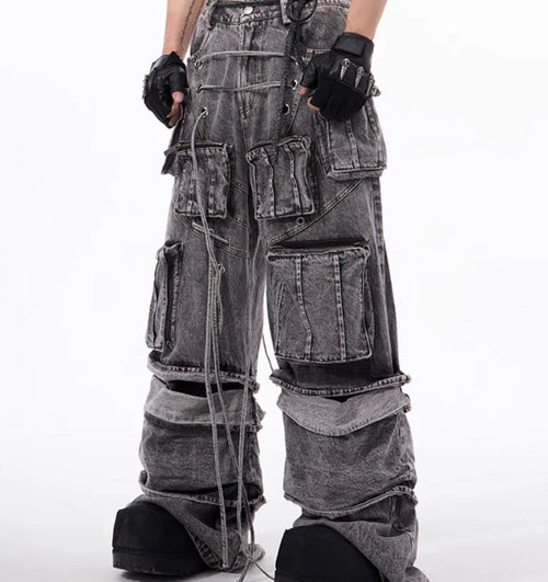Grey distressed denim overalls with rope stitching detail on a hanger.