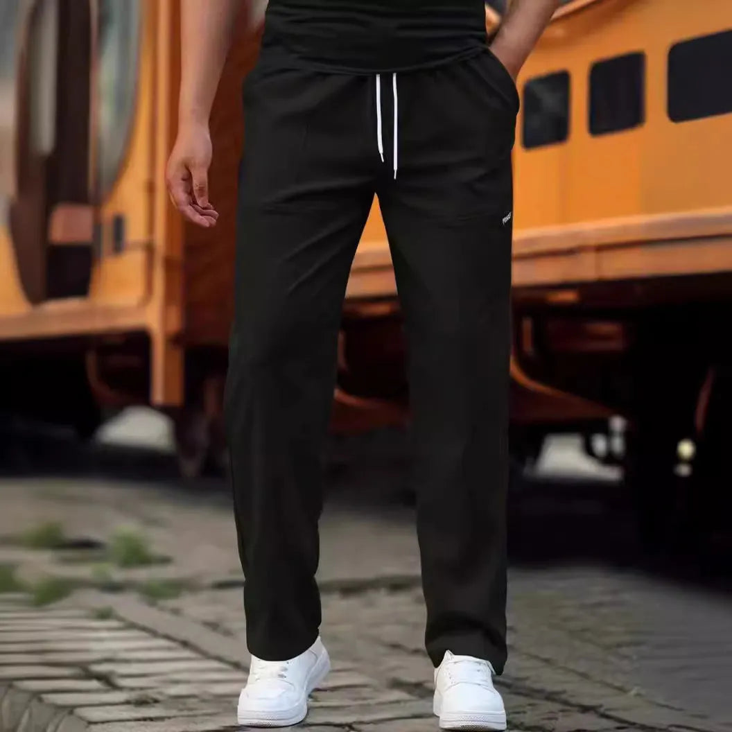 Men's light grey polyester trousers for spring and autumn casual wear, shown in Asian sizing.