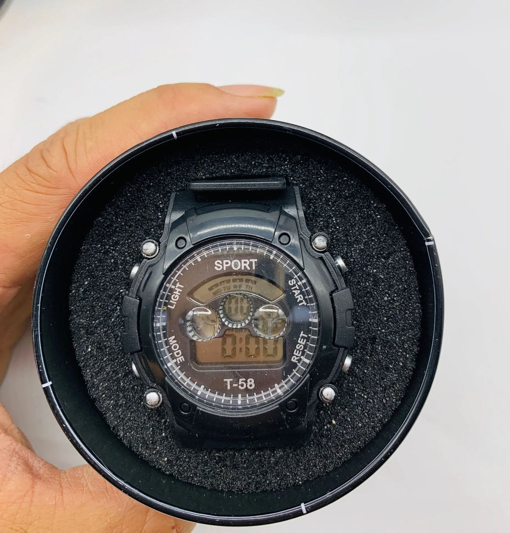 Children's digital sports watch with large black display showing time, red silicone strap, and plastic case