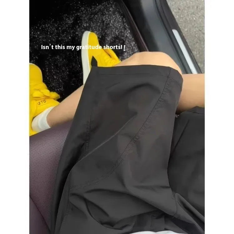 Men's beige quick-drying polyester sports shorts with a straight leg and elastic waistband.