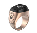 Zikr1 smart ring in black, green, rose gold, or silver on charging case with OLED display showing dhikr count.