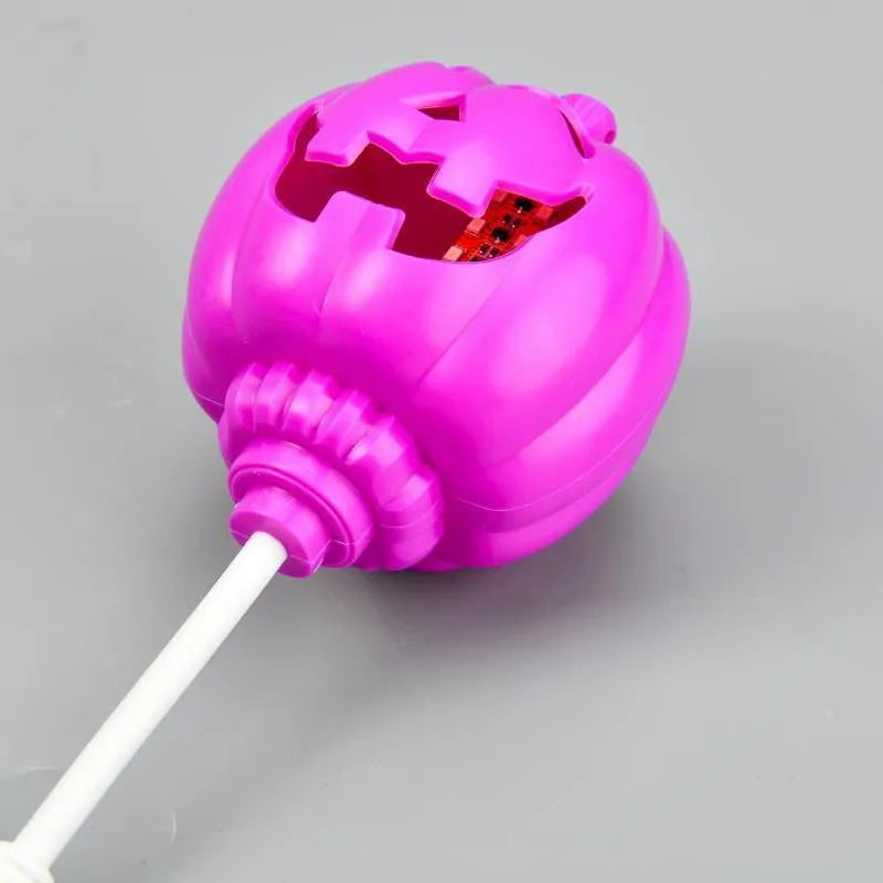 Plastic pumpkin-shaped USB lamp emitting purple or yellow light, 8.3cm wide.