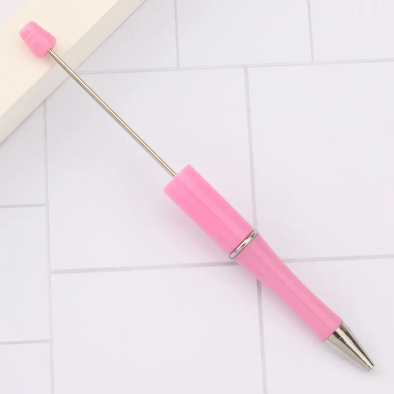 Creative ballpoint pen with multicoloured spinning plastic beads on a steel wire frame.