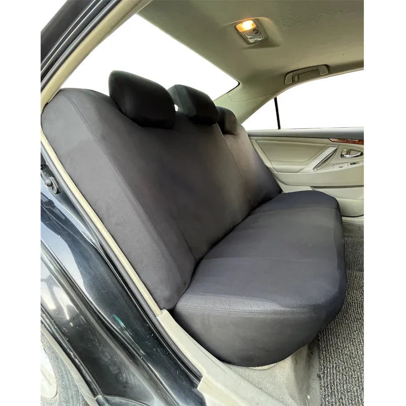 Blue polyester car seat cover with eyelet stitching on a vehicle front seat.