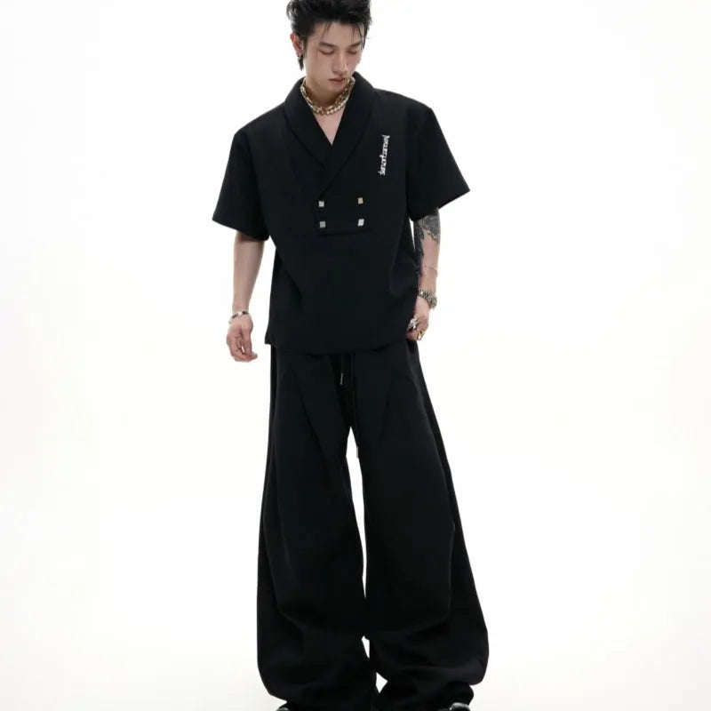 Men's dark grey cotton sports suit with metal embellishments, V-neck padded shoulders, short sleeves, and matching shorts