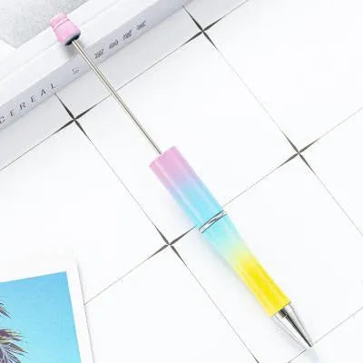Creative ballpoint pen with multicoloured spinning plastic beads on a steel wire frame.