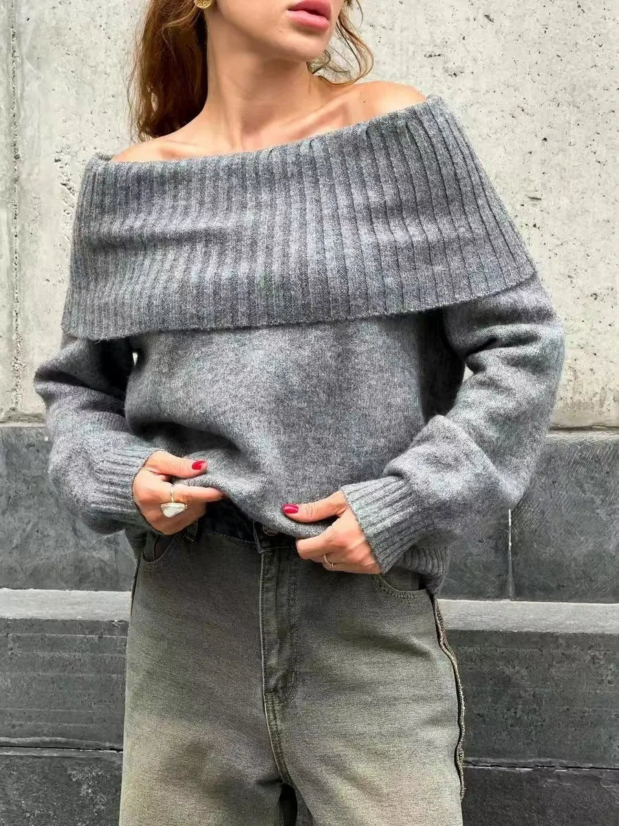 Grey off-the-shoulder sweater with a 3D pattern and strapless design, laid flat.