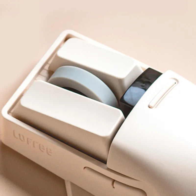 Xiaoqiao tofu colour wireless mouse with seven buttons and a scroll wheel on a desk.