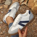 Blue women's flat German training shoes with lace-up front and rubber sole.