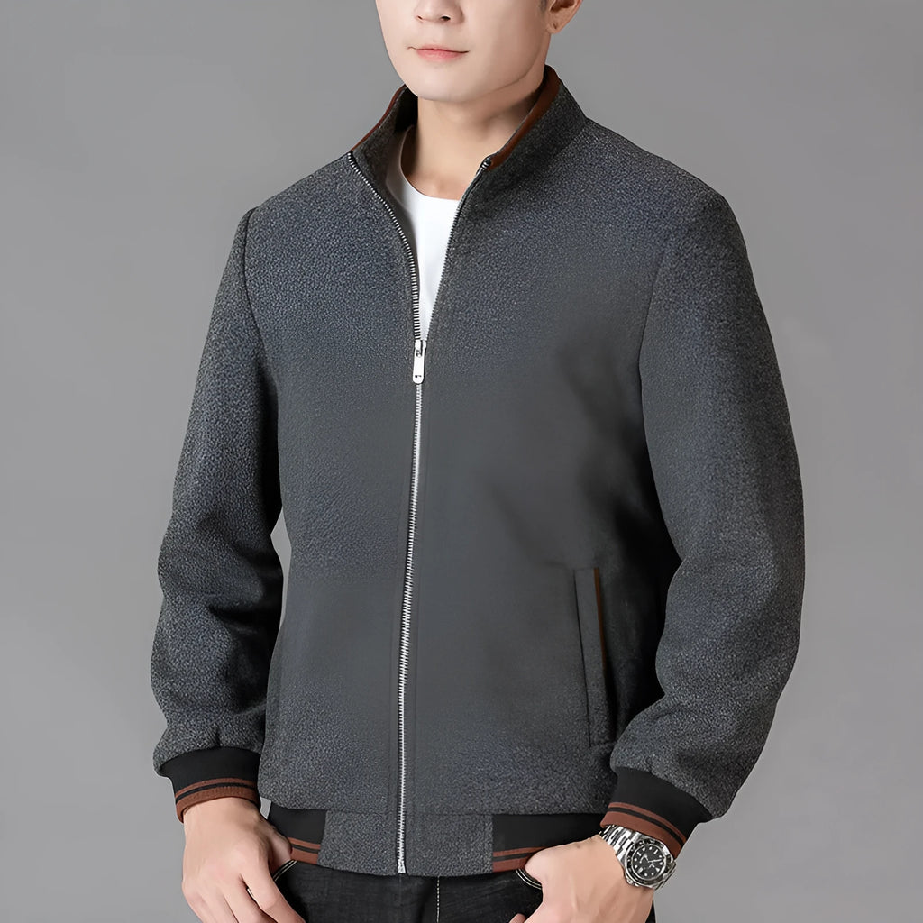 A grey men's sporty fleece jacket with long sleeves and a stick pocket, shown on a hanger.