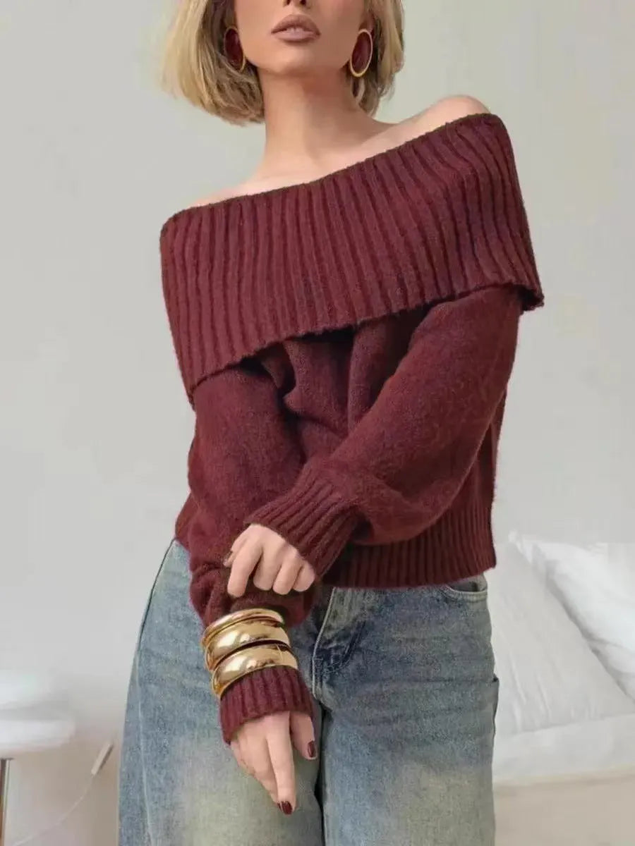 Grey off-the-shoulder sweater with a 3D pattern and strapless design, laid flat.