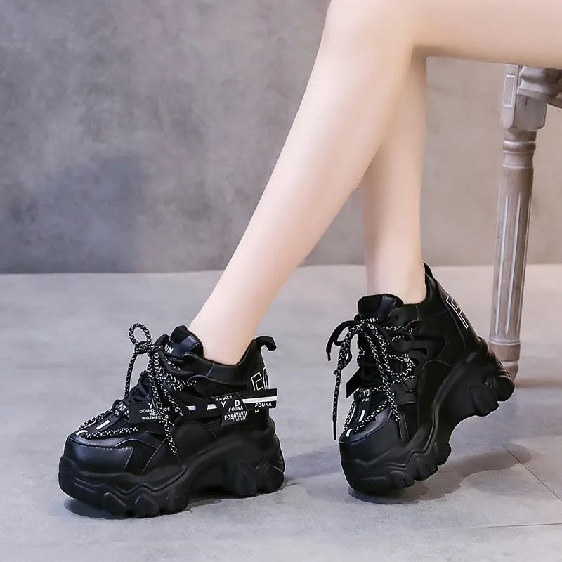 White and black women's low-top mesh platform sports shoes with cross strap and round toe.