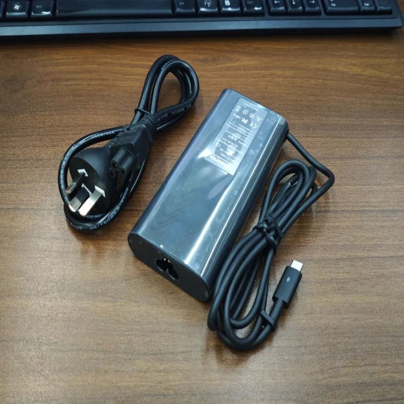 Black 65W Type-C laptop power adapter with multiple international power cords