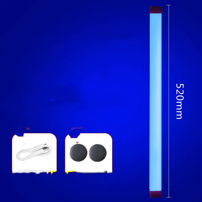 Blue and purple rechargeable LED tube light with USB cable on a dark background.