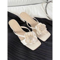 Women's sandal with chunky heel, square toe, and one-line strap in cream-white satin.