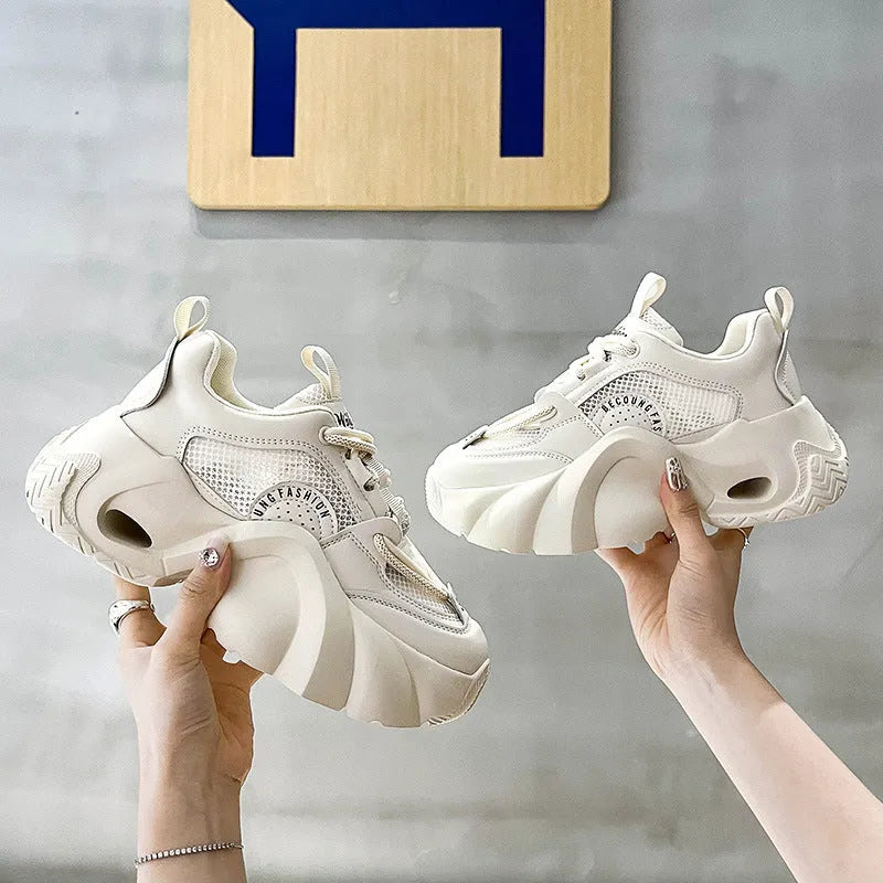 Women's casual sneakers in beige with thick sole, cross shoulder straps, and mesh lining.