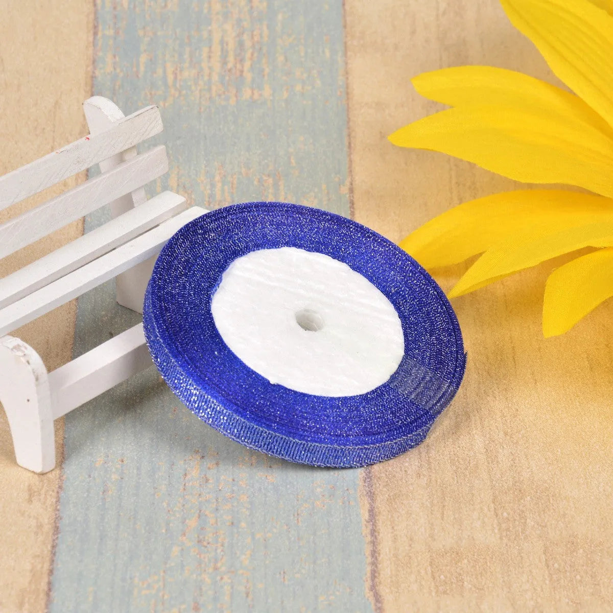 Polyester ribbon spool in metallic colours for decorative clothing and gift packaging trim