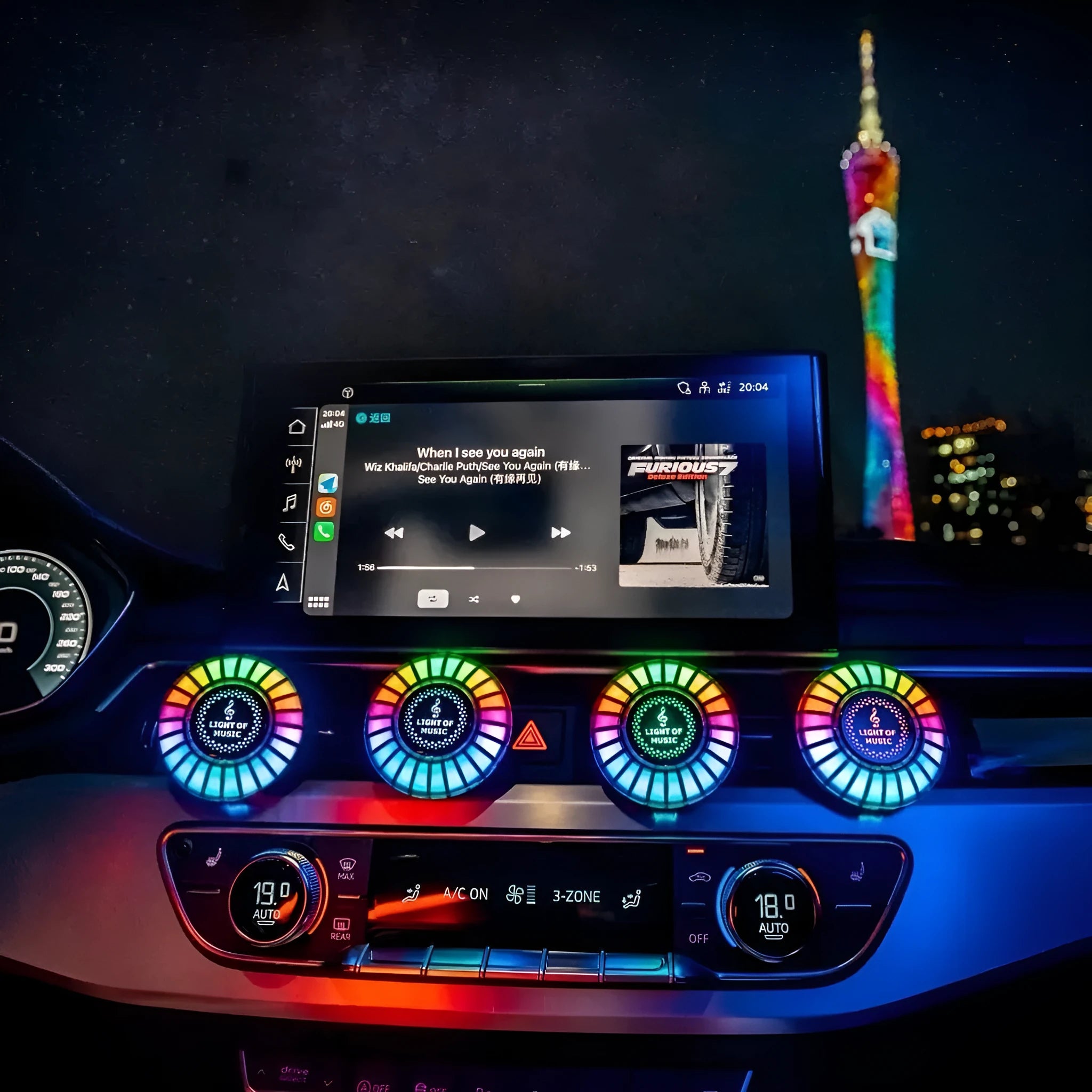 3D RGB car atmosphere light with aromatherapy mounted on a vehicle air outlet vent showing colorful lighting effects.