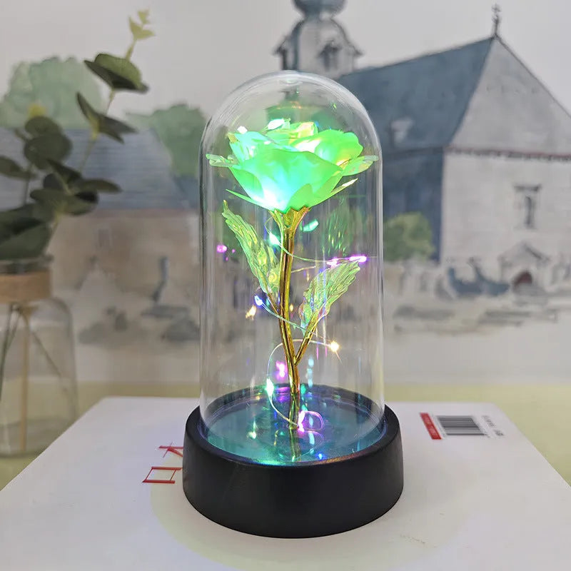 Small plastic night lamp with floral decoration and coloured light options on a black base.
