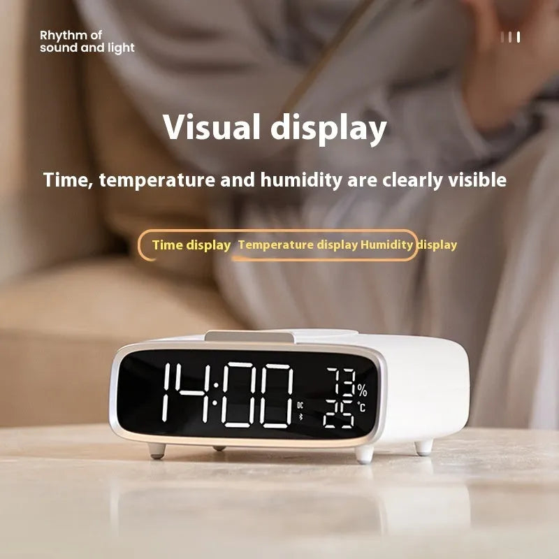 White Bluetooth speaker with integrated wireless charging pad and night light function