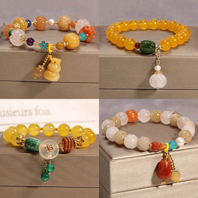 Yellow agate crystal bracelet with gold silk cord and adjustable sliding knot on a wrist.