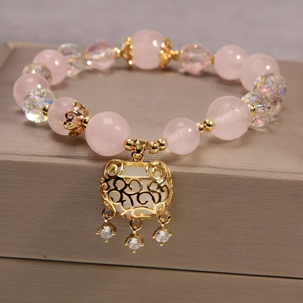 Yellow agate crystal bracelet with gold silk cord and adjustable sliding knot on a wrist.