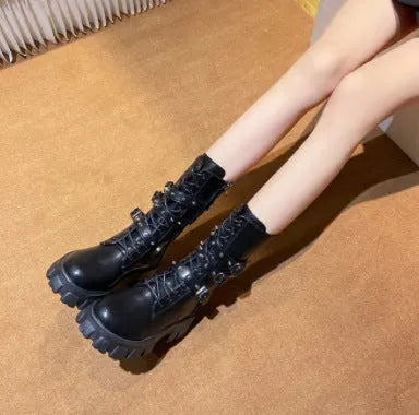 Black women's mid-calf boots with metal buckle detail and a side zip fastening.