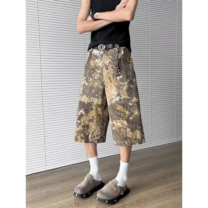 Yellow women's cropped jeans with a large snake camouflage pattern tooling print on the denim fabric.