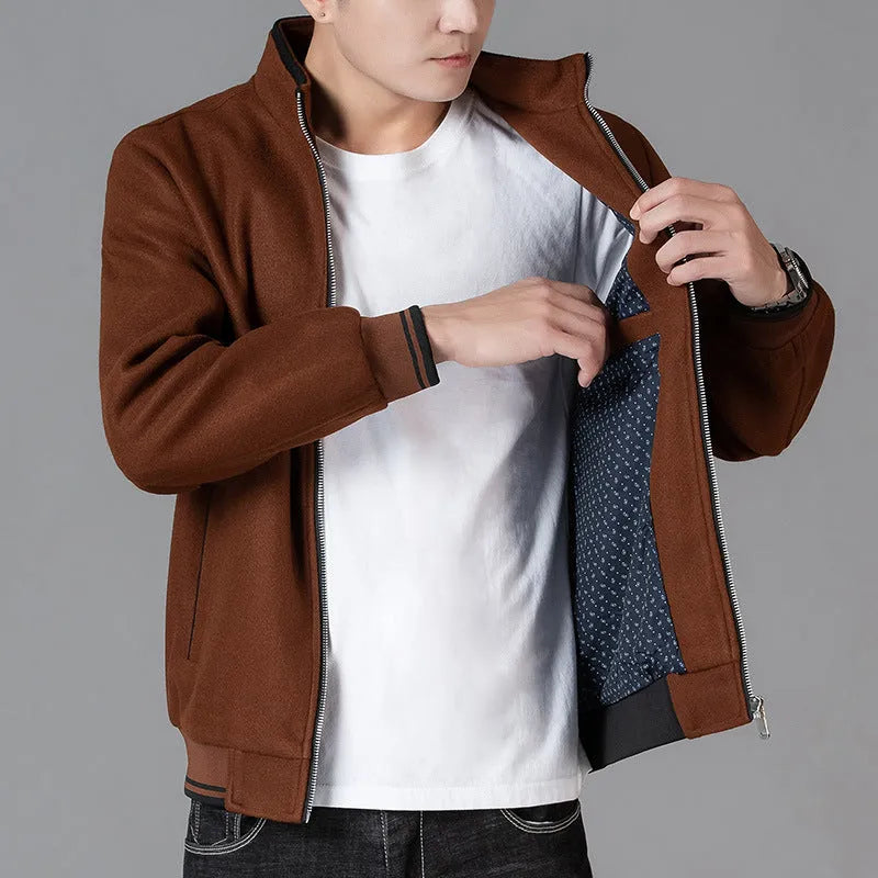 A grey men's sporty fleece jacket with long sleeves and a stick pocket, shown on a hanger.