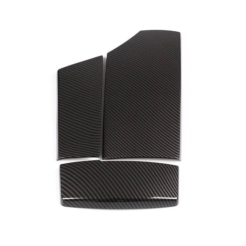 Three ABS armrest box protective covers with carbon fibre diagonal weave pattern showing polished shiny surface