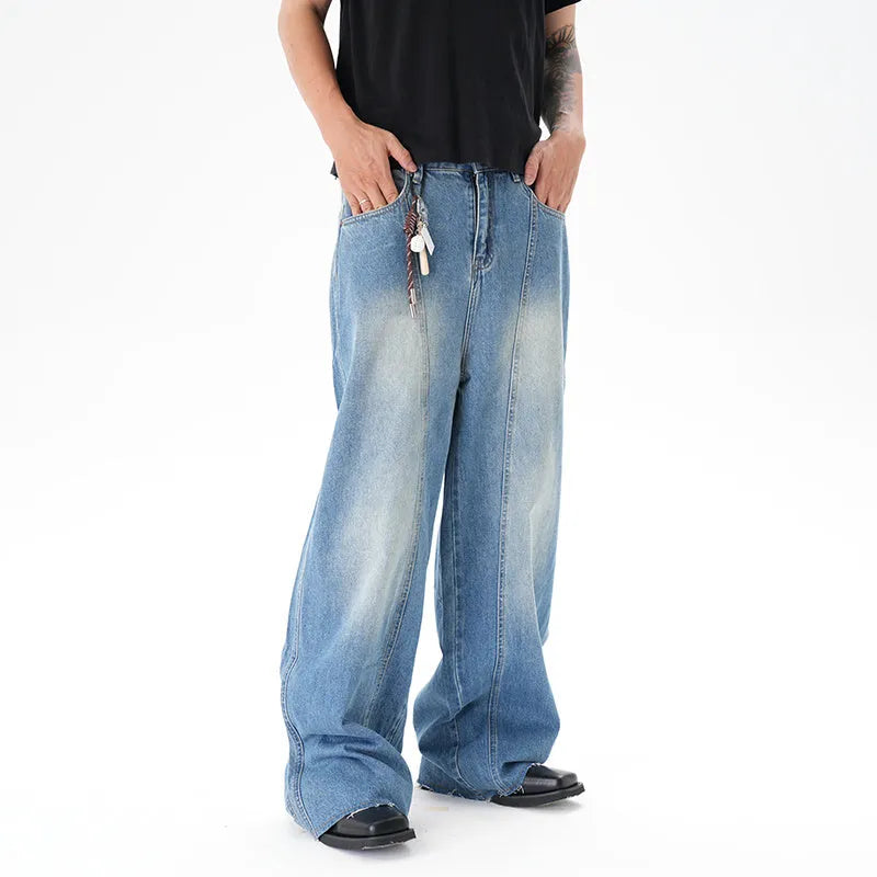 Light blue vintage washed wide leg machete jeans with a straight fit and zipper fly on a model.