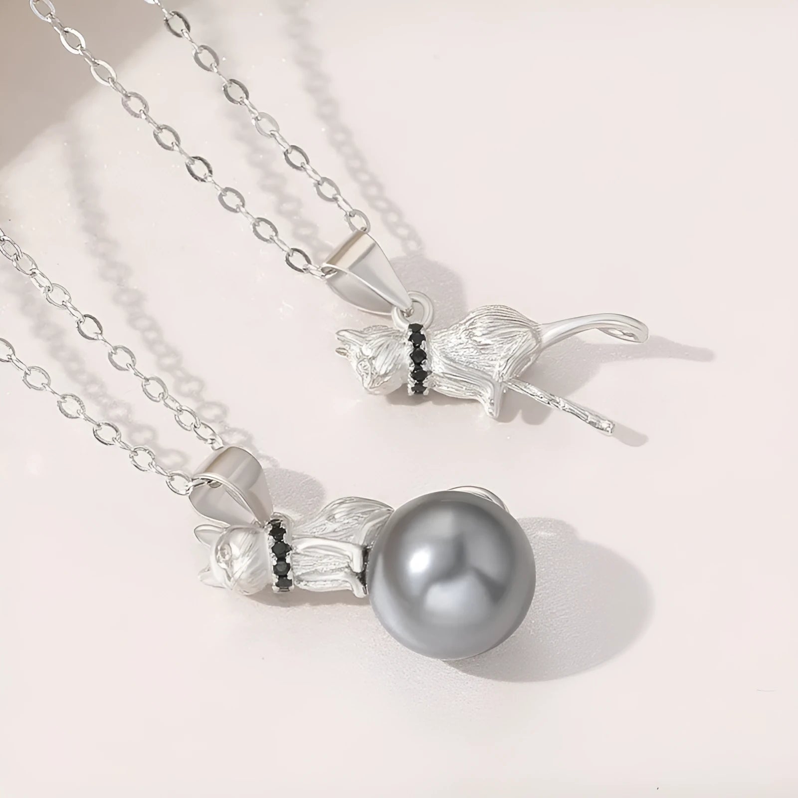 Close-up of a sterling silver cat pendant on a chain, showing the D2113 or D2114 finish variant.