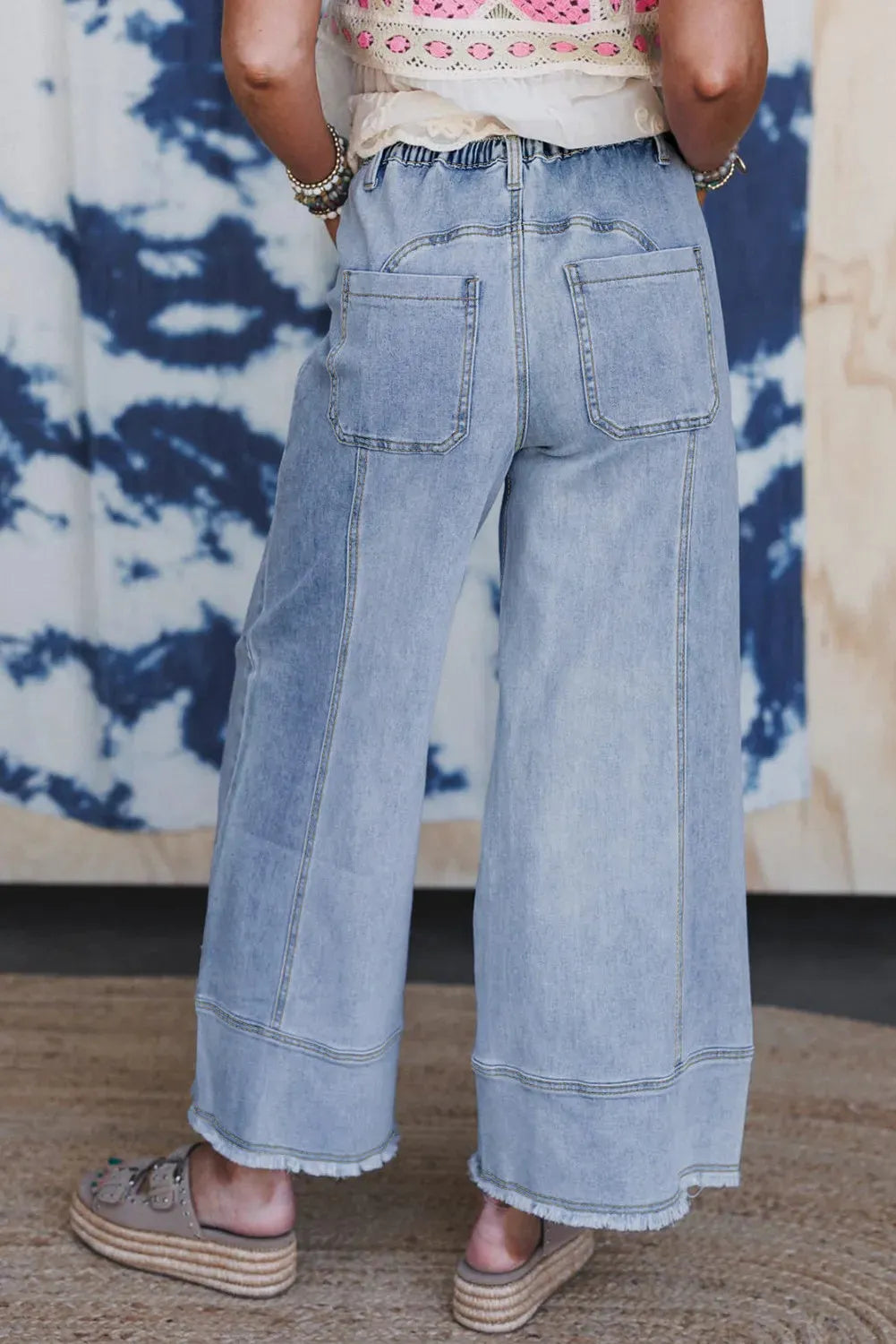Beau Blue women's wide leg denim pants with drawstring waist and raw hem detailing.