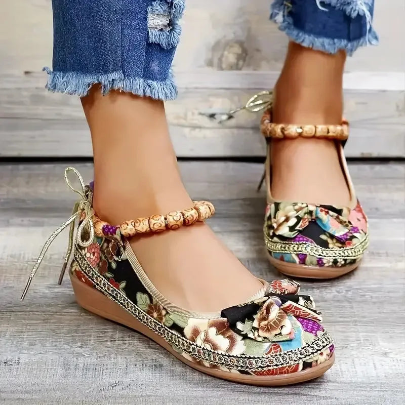 Women's black ethnic style platform sandals with elastic band closure, fabric upper, and round toe.