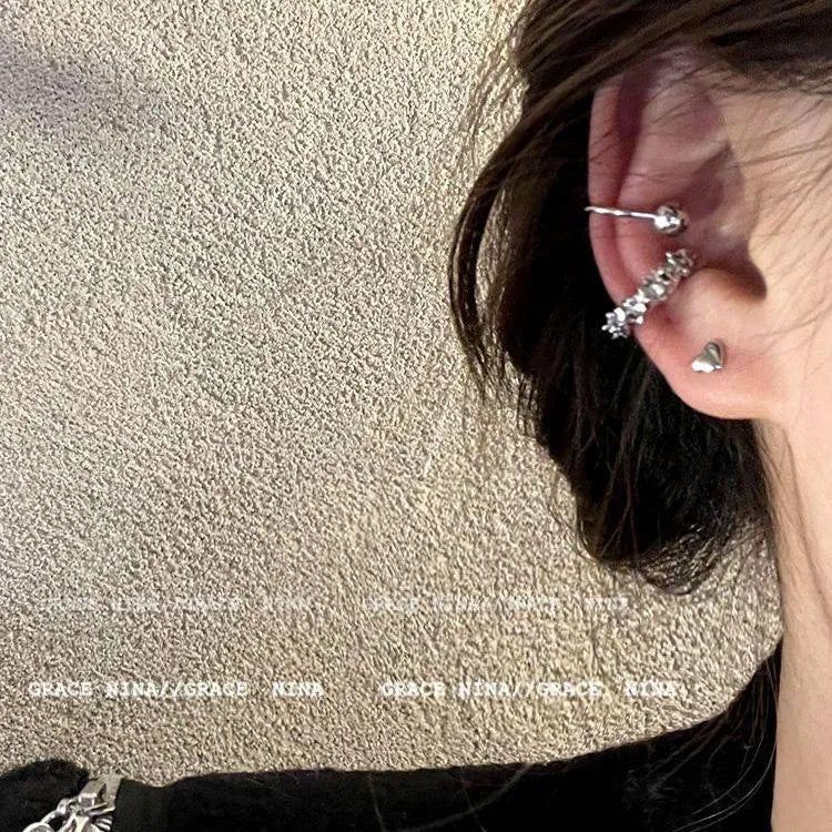 A pair of frosty-finish geometric alloy earrings with ear clip fastenings.