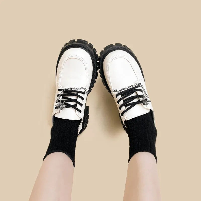 Women's Duke Asterism coloured loafers with a metal cross shoulder strap and round toe.