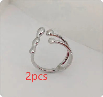 Adjustable brass opening ring with spherical design in gold or silver colour