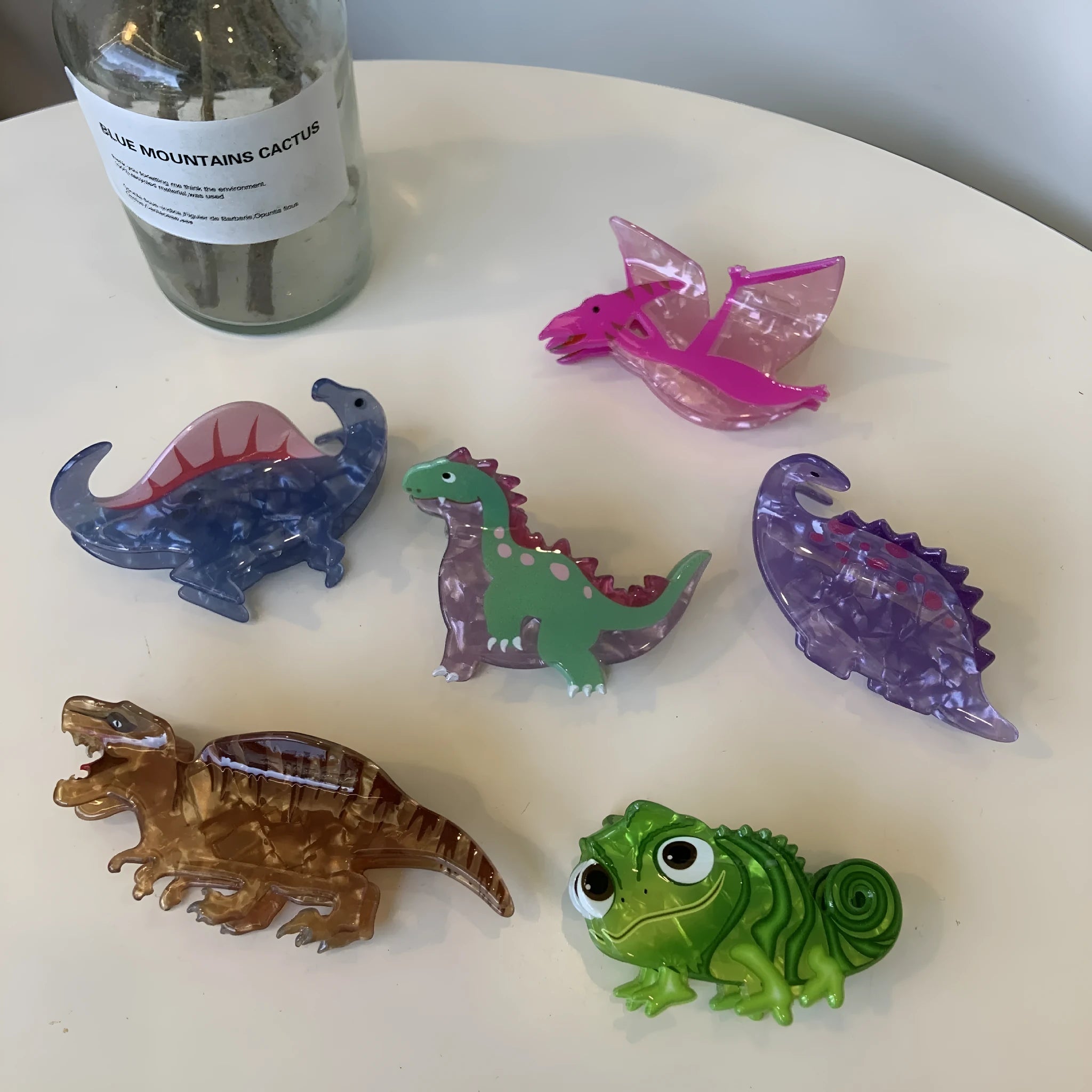 Colourful dinosaur acrylic jaw clip hairpin showing six colour variations