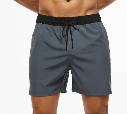 Men's blue training shorts with stitching waist detail and headband pocket for running and fitness