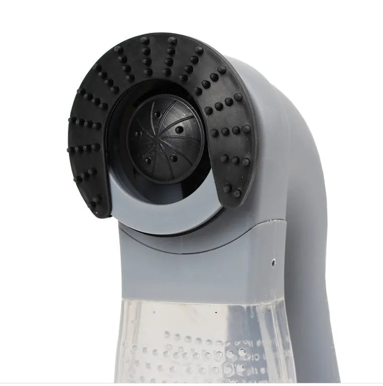 Grey portable pet hair vacuum cleaner with soft rubber head and large collection canister on a fabric sofa.