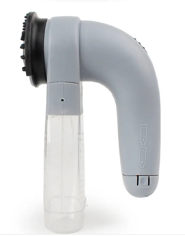 Grey portable pet hair vacuum cleaner with soft rubber head and large collection canister on a fabric sofa.