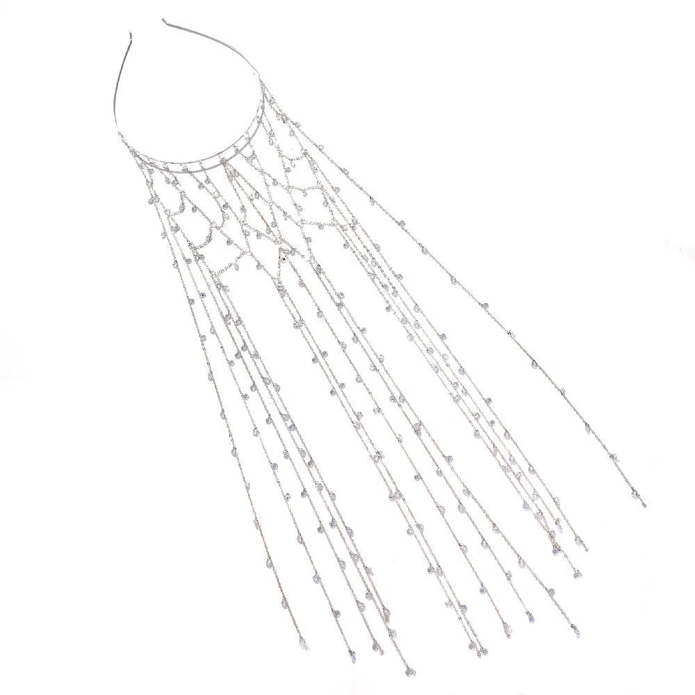 Close-up of a gold metallic mesh headband with rhinestone details and hanging tassels.