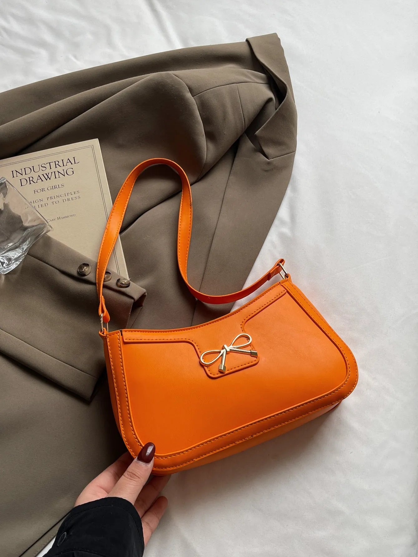 Western style PU leather shoulder bag with bow detail in horizontal square shape.