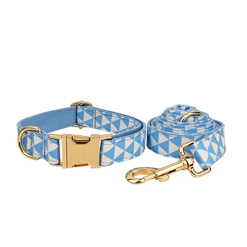 Blue triangular pattern dog harness set with matching leash, collar, and fabric bow accessory