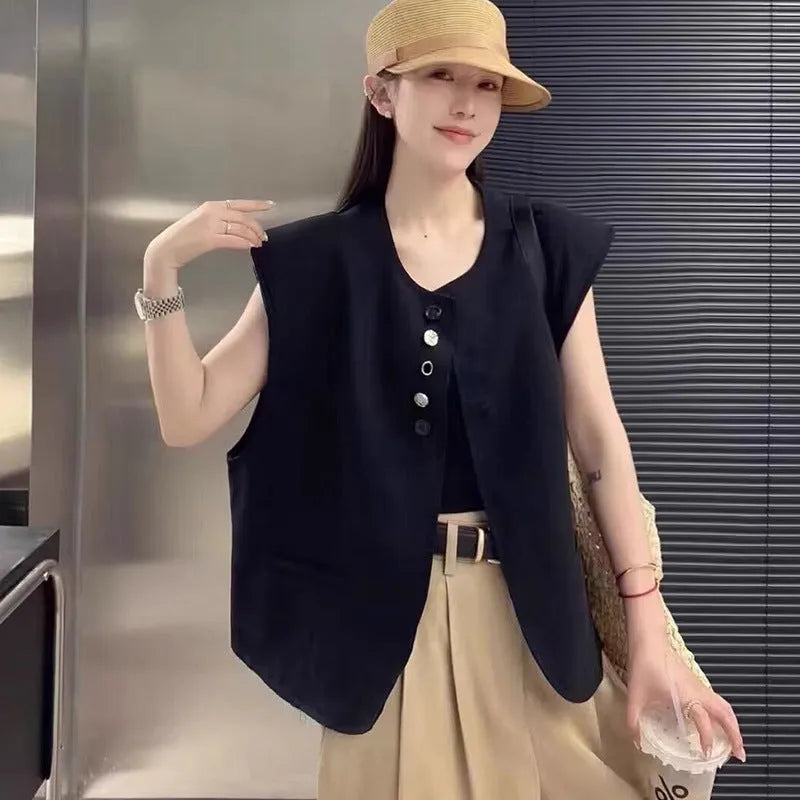 Women's loose fit polyester vest in milky white and black colours with pocket details.