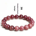 Natural strawberry quartz bracelet with geometry-shaped beads in starlight cherry red colour on a wrist.