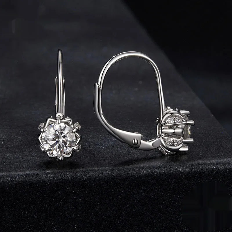 White gold plated sterling silver flower bud ear clip with a moissanite stone.