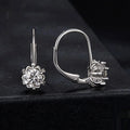 White gold plated sterling silver flower bud ear clip with a moissanite stone.