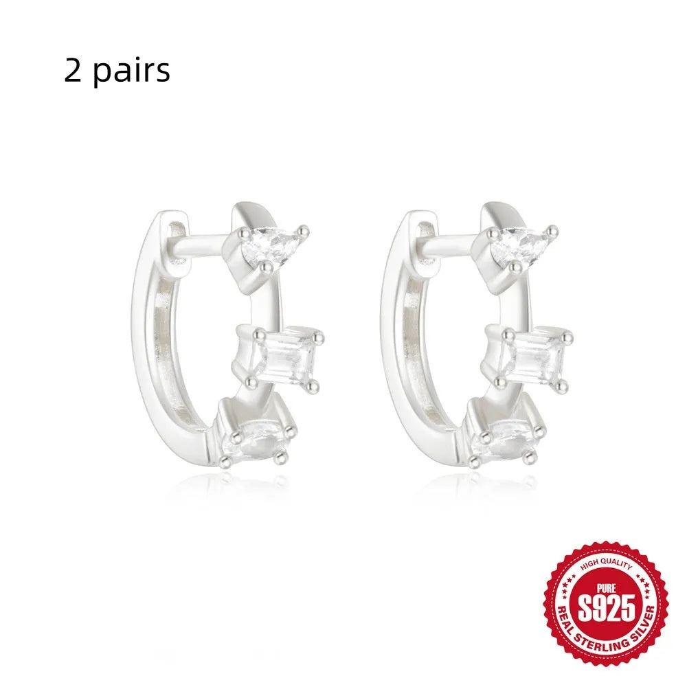 Sterling silver geometric stud earrings with small round diamond detailing in gold and silver electroplated finishes