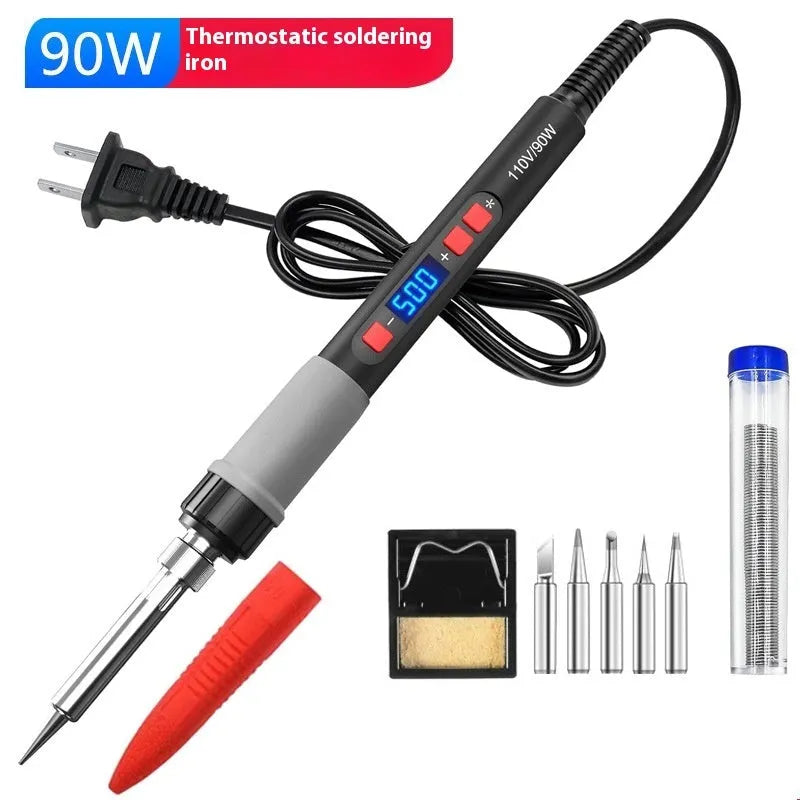 Grey 90W electric soldering iron kit with ceramic heating core, five tips, sponge, and tin wire on a workbench.